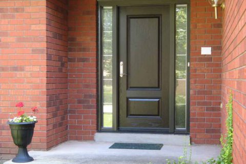 Black fibreglass entry doors with sidelights A black fiberglass entry door with sidelights.
